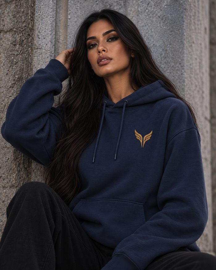 A woman in a midnight blue hooded sweatshirt with the gold wings on the left chest.
