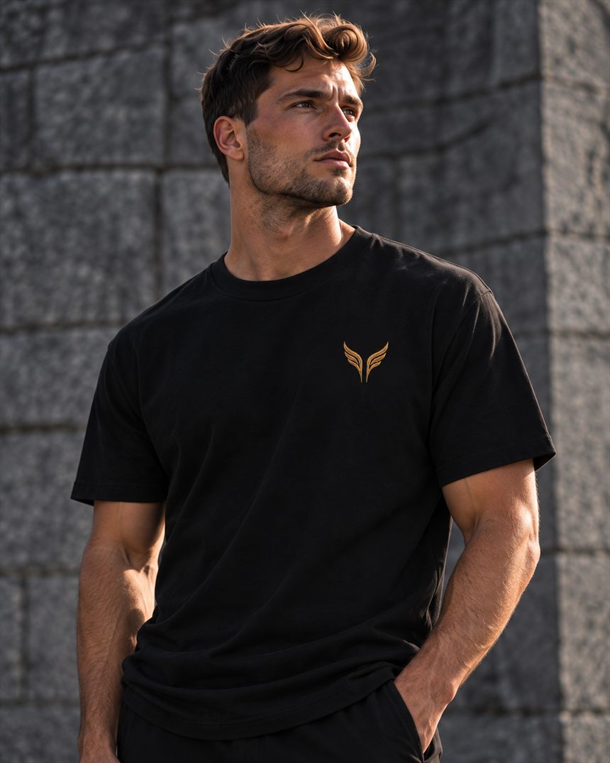 A man in a black t-shirt with the gold wings on the left chest.